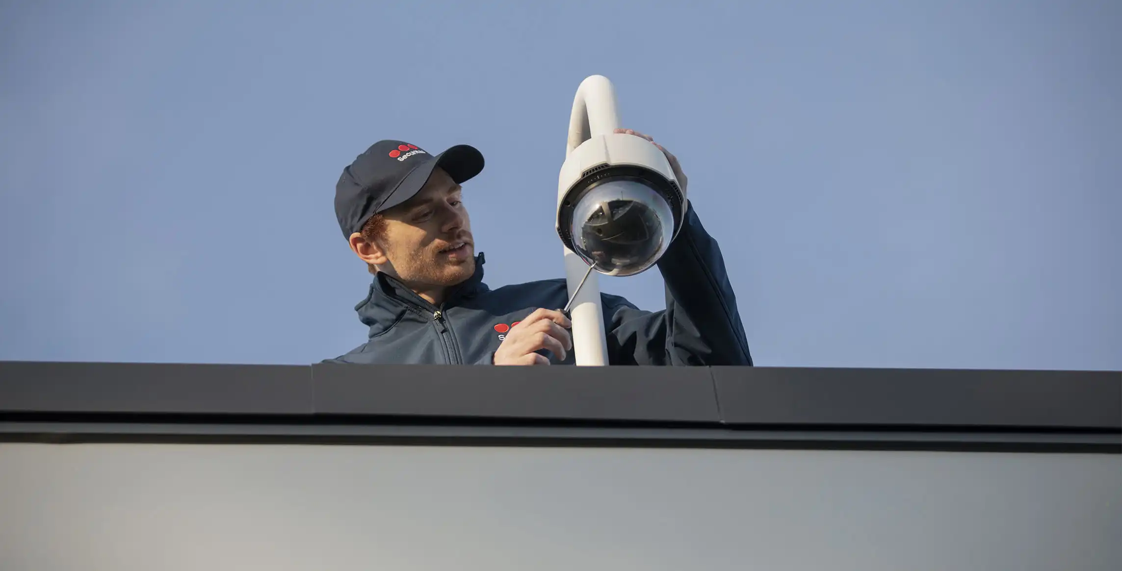 An officer installs a security camera