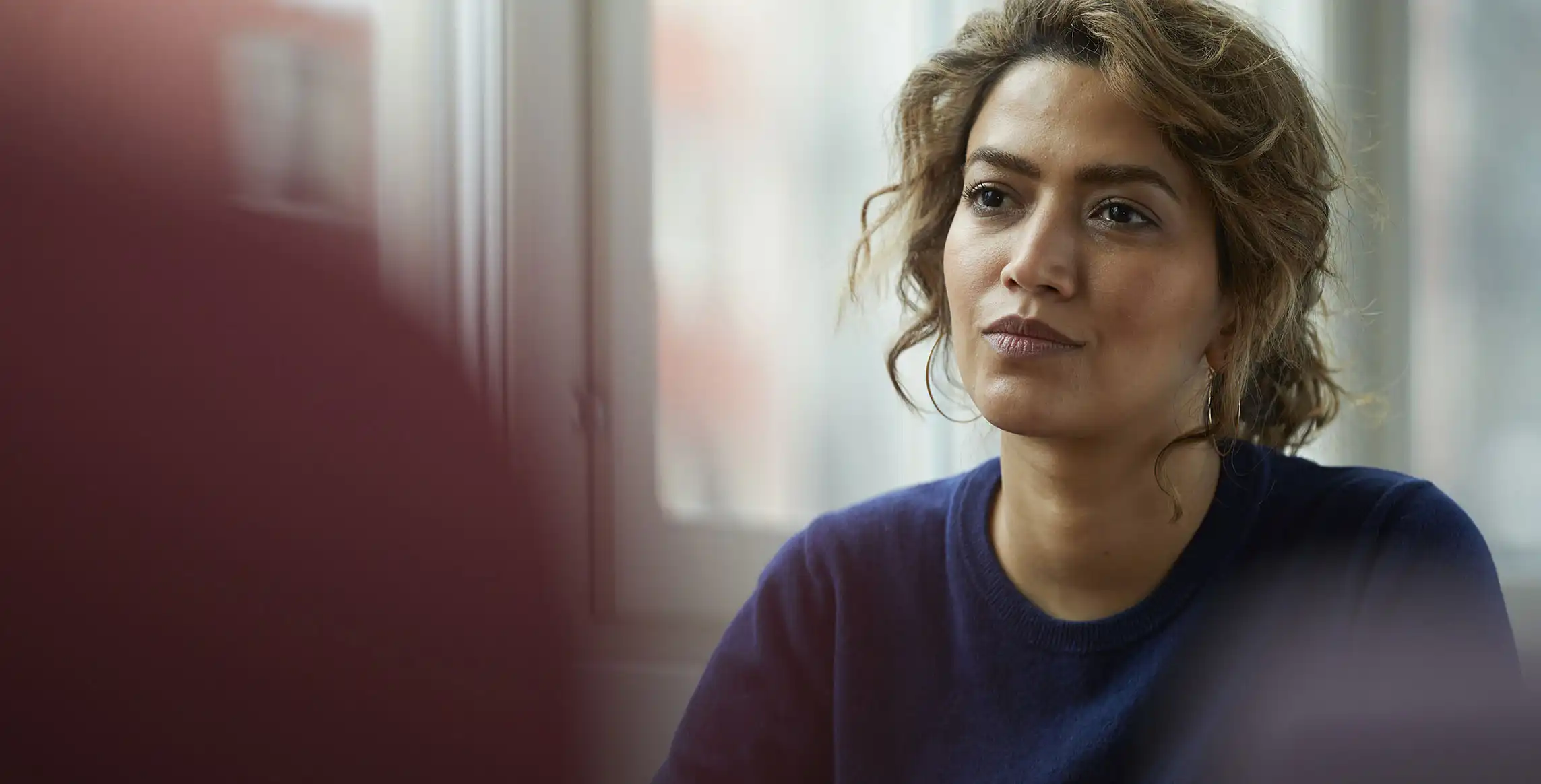 Closeup of a woman in discussion with a client.