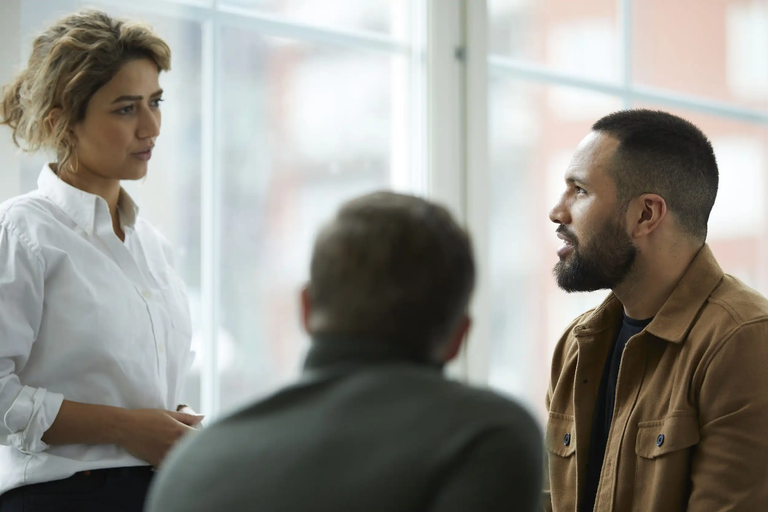 Three people in a meeting.