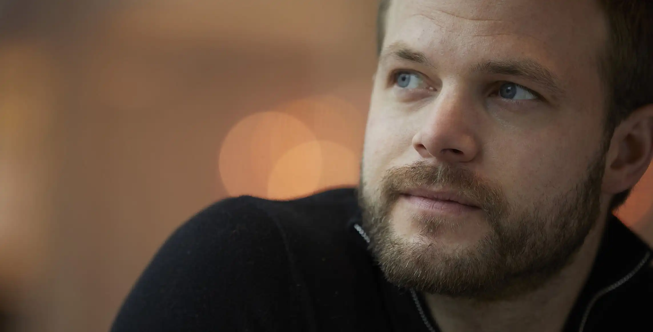 Closeup of a man looking away in the distance.