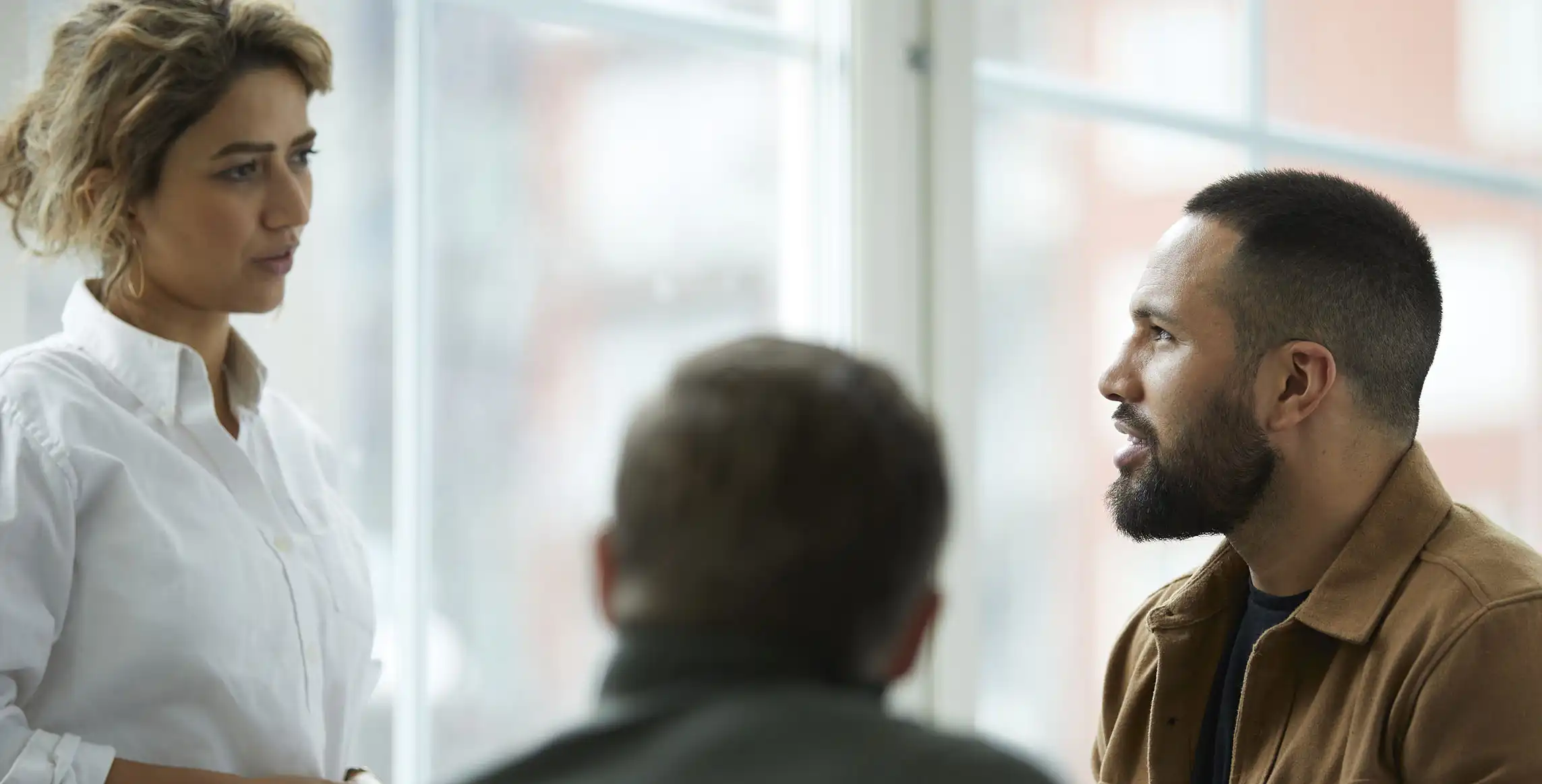 Three people in a meeting.